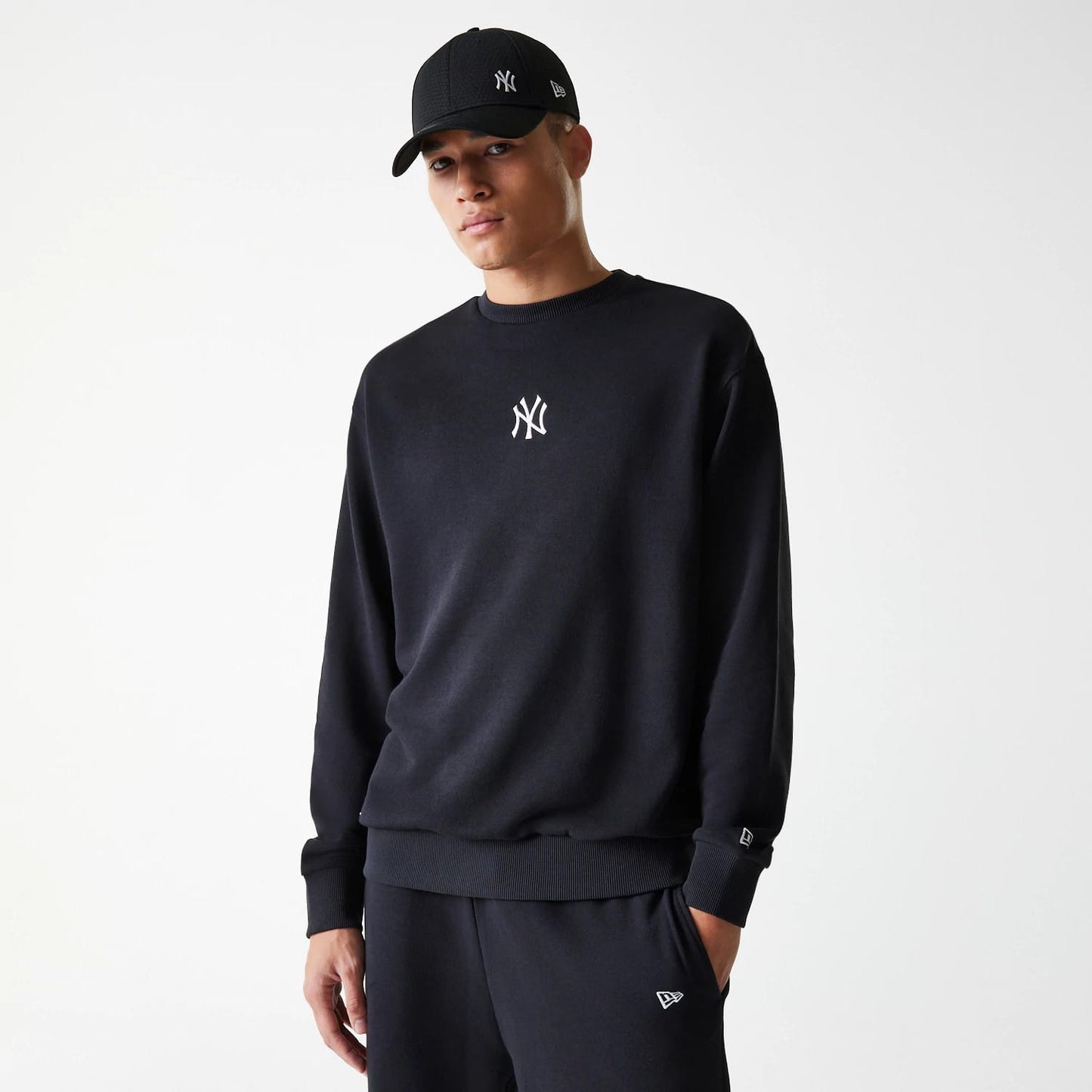 The Male model is wearing New York Yankees MLB League Essential Midi Black Oversized Crew Neck Sweater 4