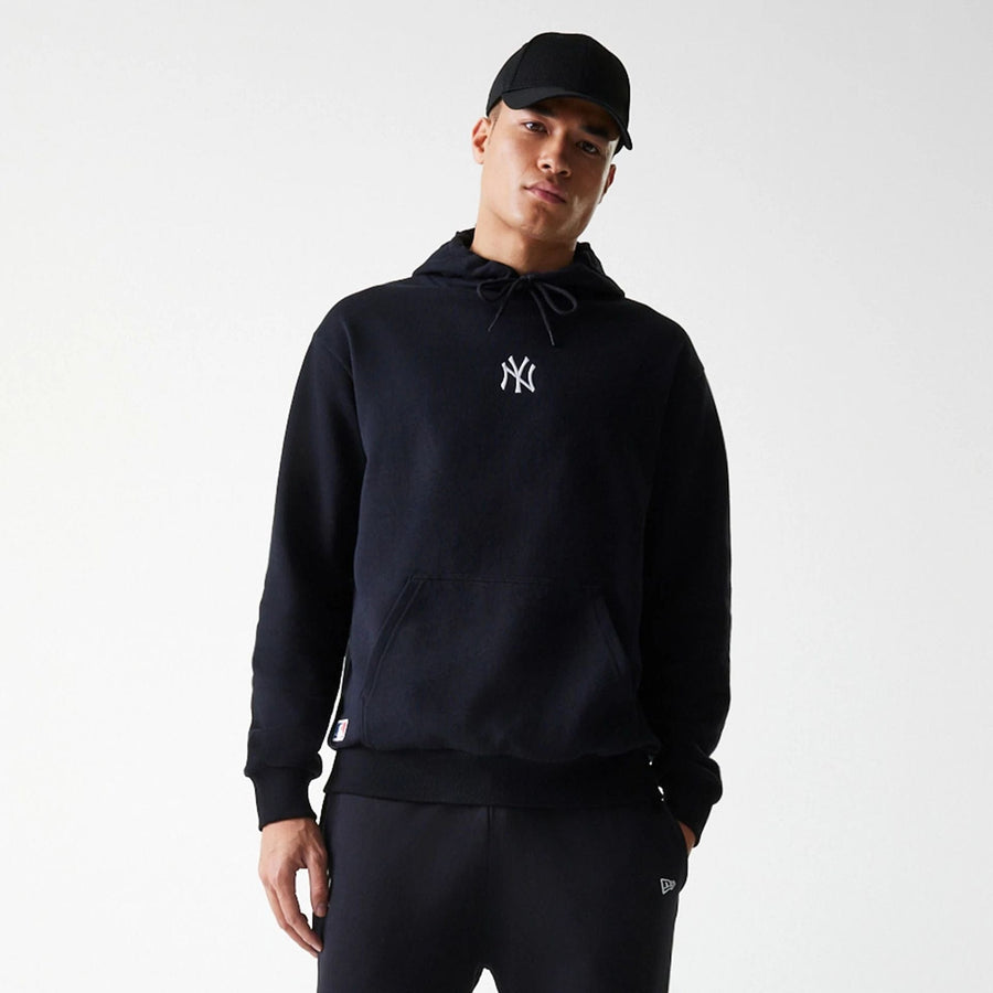 The Male model is wearing New York Yankees MLB League Essential Black Oversized Pullover Hoodie 3