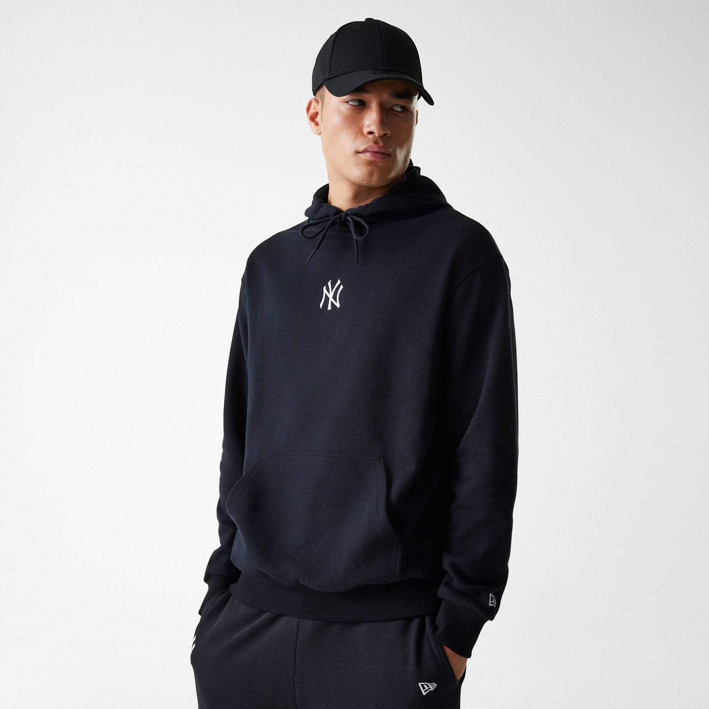 The Male model is wearing New York Yankees MLB League Essential Black Oversized Pullover Hoodie 1