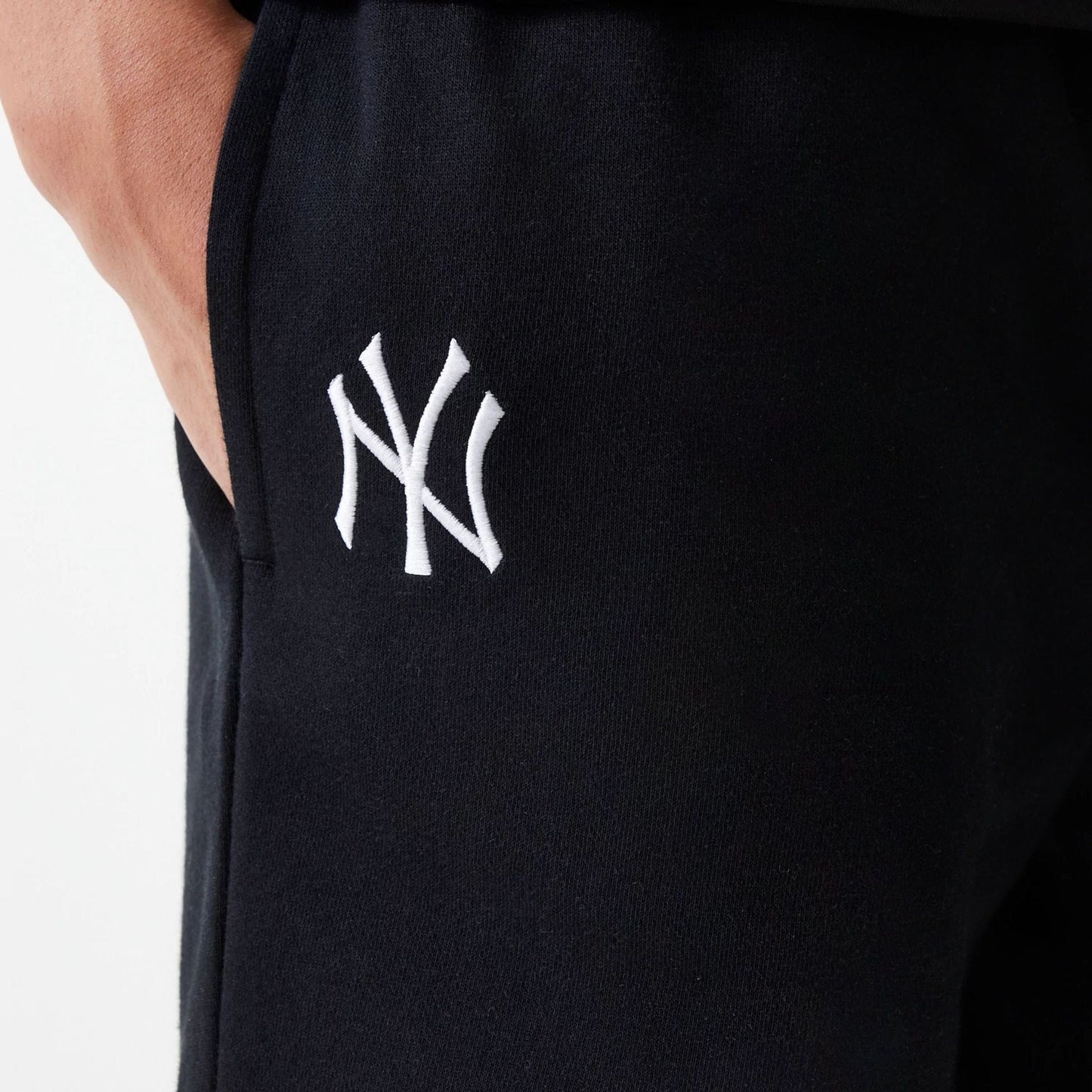 The Male model is wearing New York Yankees MLB League Essential Midi Black Shorts 4