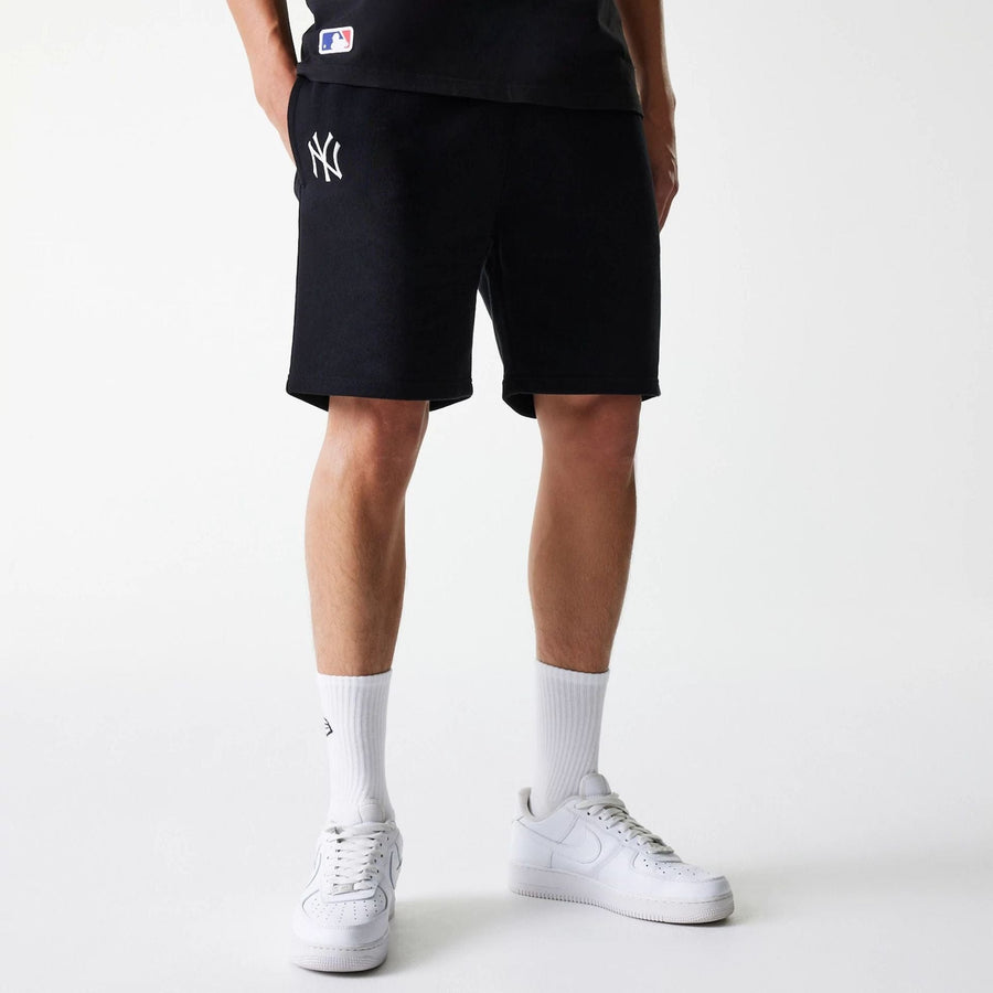 The Male model is wearing New York Yankees MLB League Essential Midi Black Shorts 1