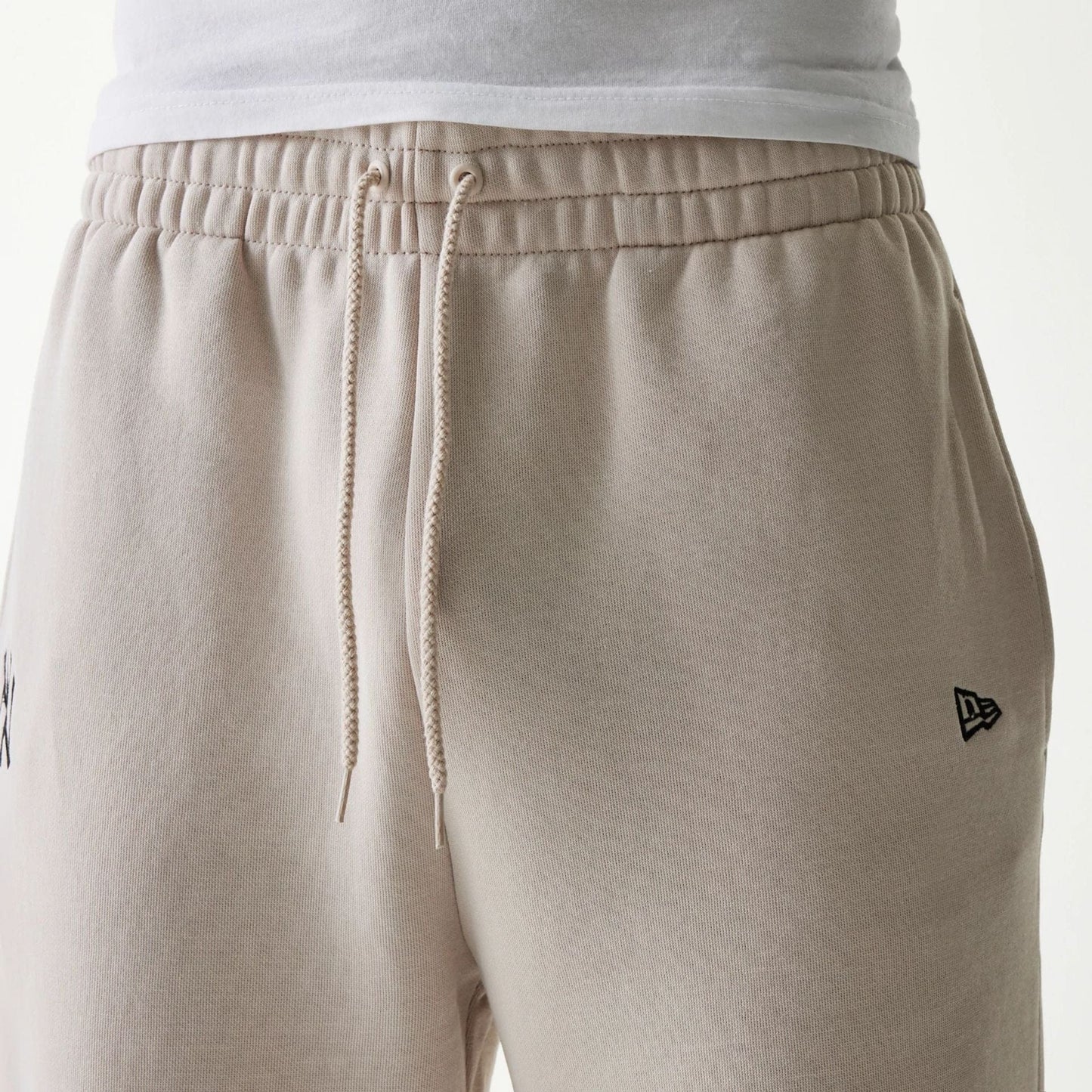 The Male model is wearing New York Yankees MLB League Essential Cream Joggers 3