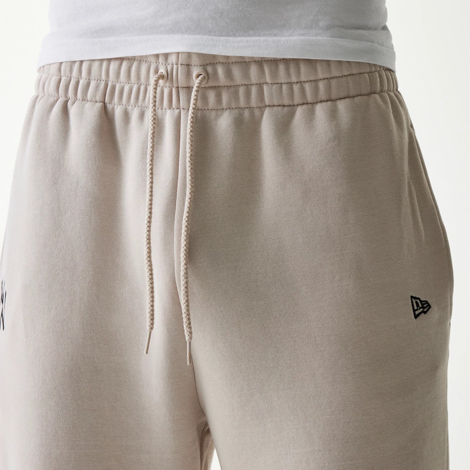 The Male model is wearing New York Yankees MLB League Essential Cream Joggers 3