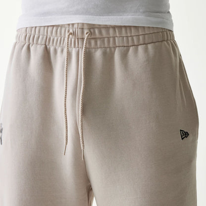 The Male model is wearing New York Yankees MLB League Essential Cream Joggers 3