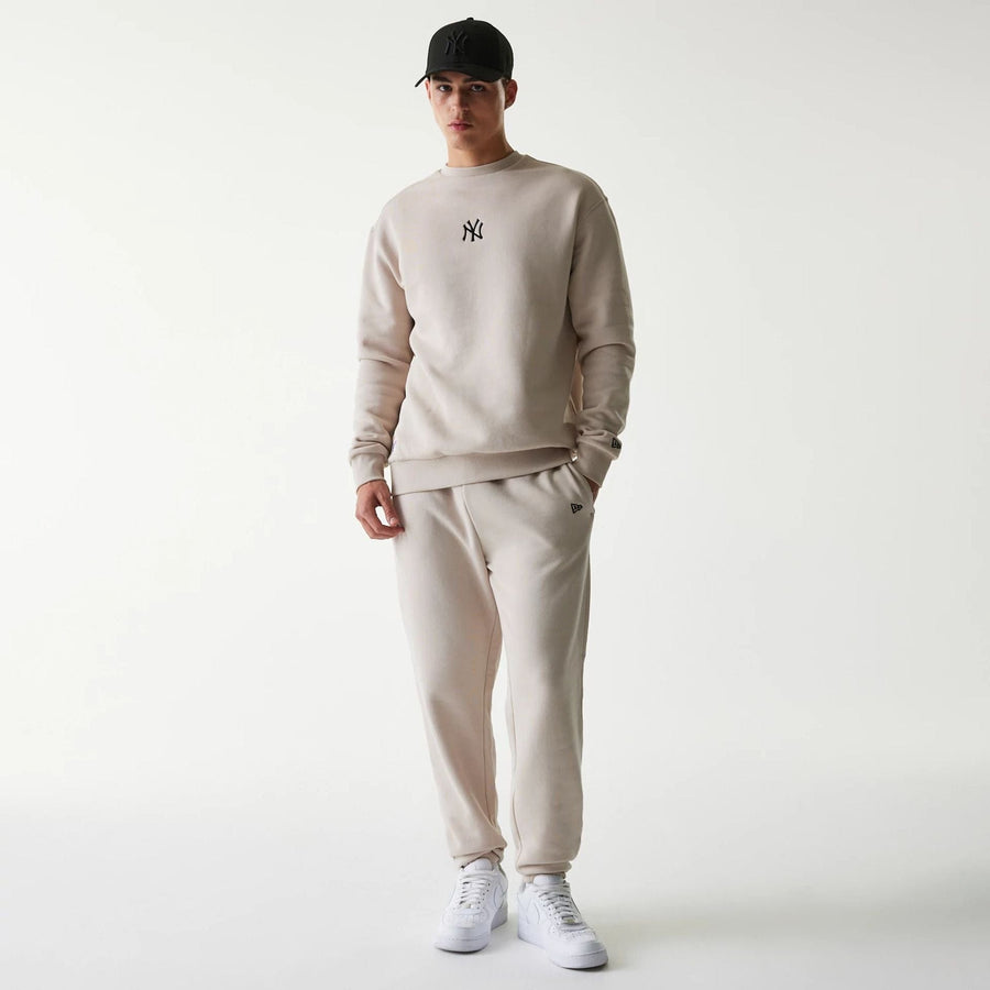The Male model is wearing New York Yankees MLB League Essential Cream Joggers 8
