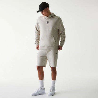 The Male model is wearing New York Yankees MLB League Essential Midi Cream Shorts 8