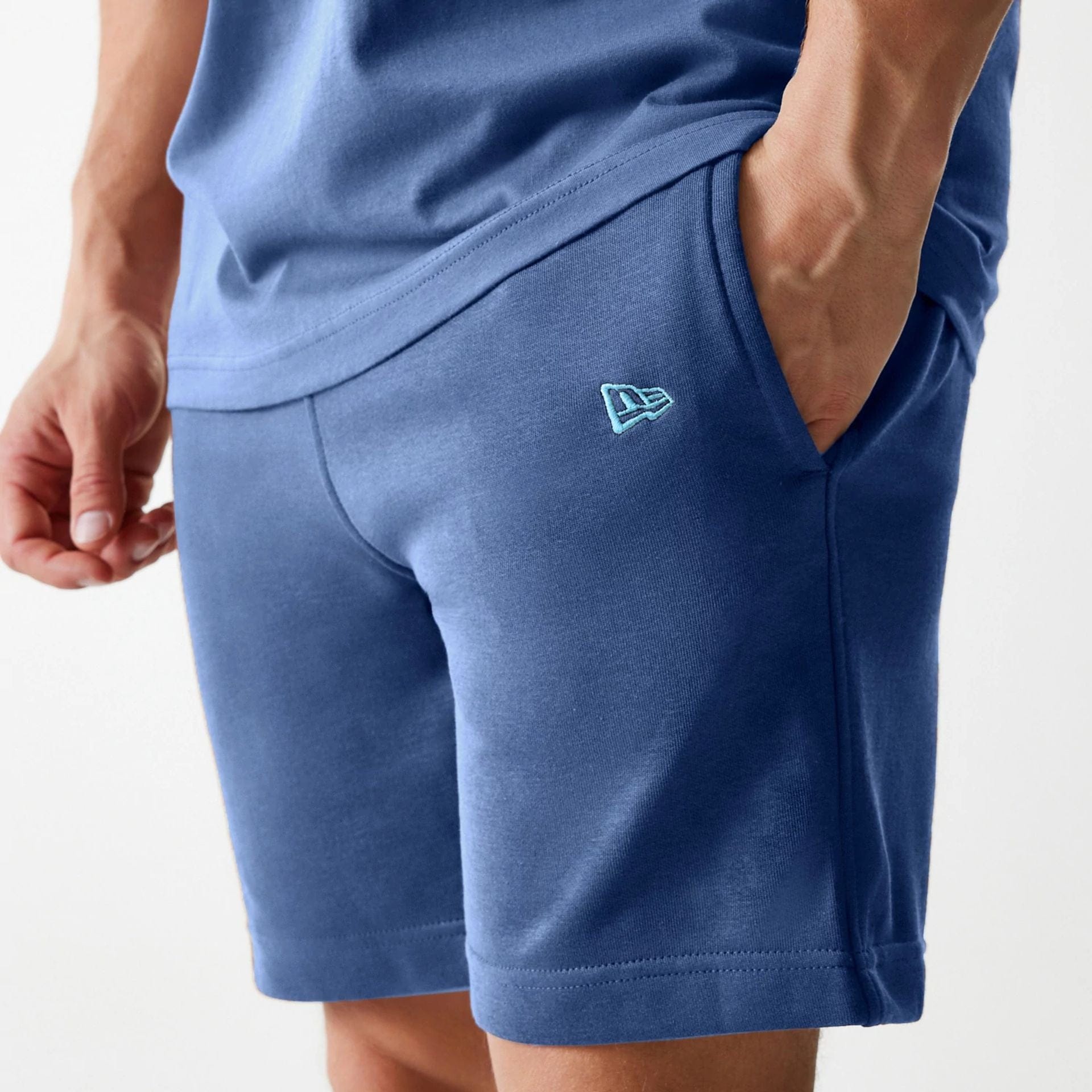 The Male model is wearing LA Dodgers MLB Midi League Essential Dark Blue Shorts 5