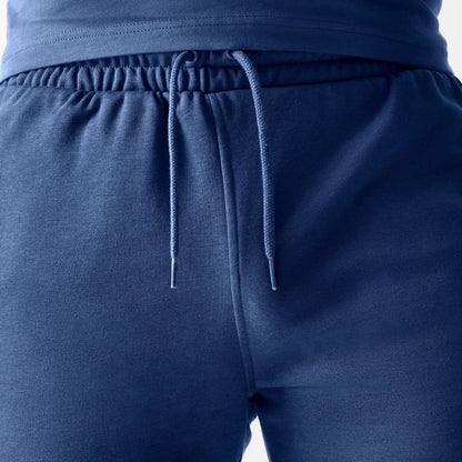 The Male model is wearing LA Dodgers MLB Midi League Essential Dark Blue Shorts 6