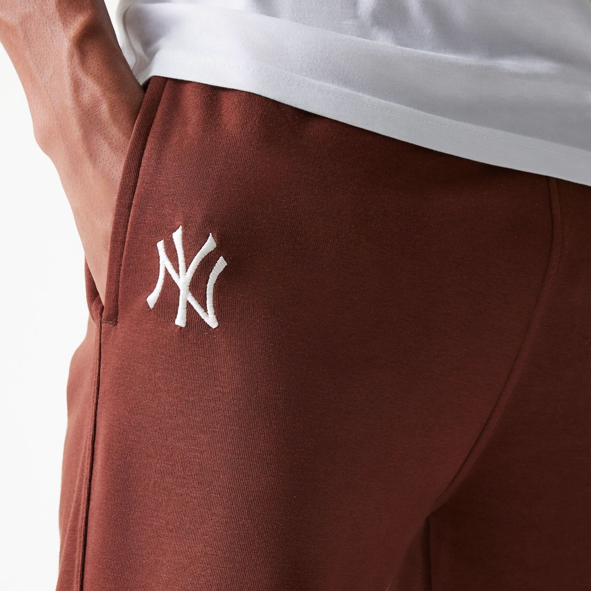 The Male model is wearing New York Yankees MLB Midi League Essential Brown Joggers 4