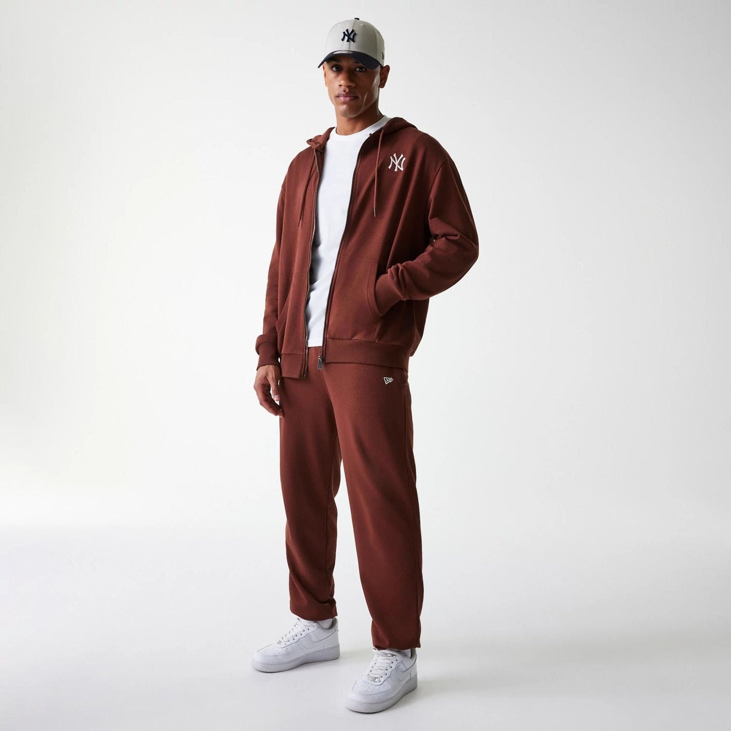The Male model is wearing New York Yankees MLB Midi League Essential Brown Joggers 8