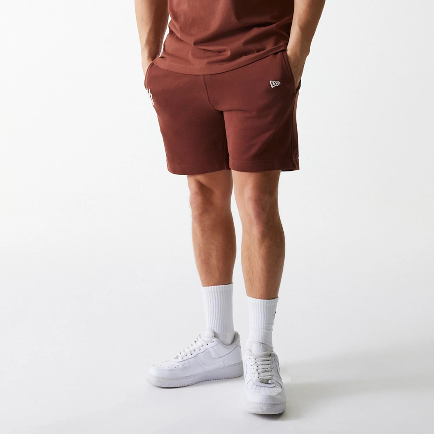 The Male model is wearing New York Yankees MLB Midi League Essential Brown Shorts 6