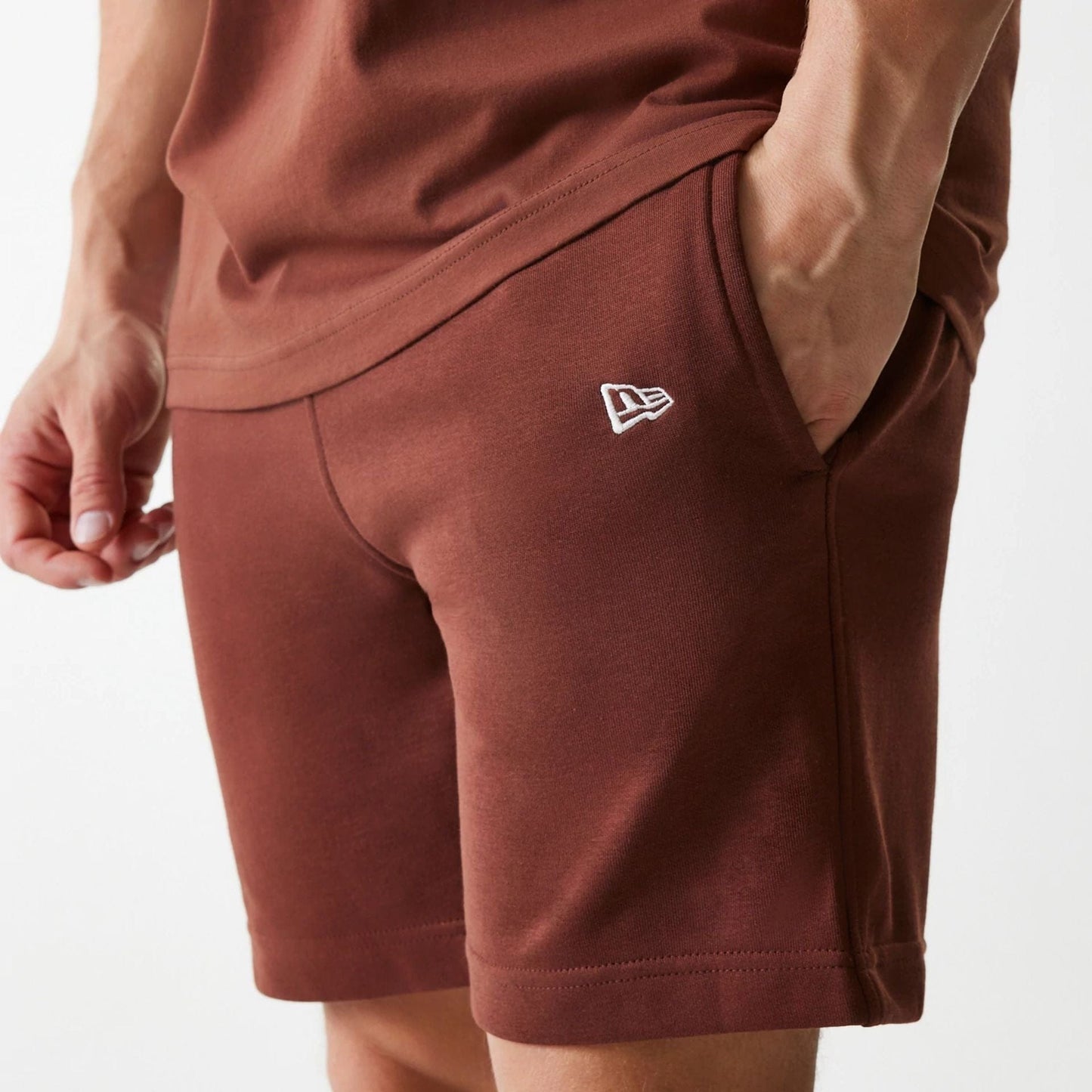 The Male model is wearing New York Yankees MLB Midi League Essential Brown Shorts 4