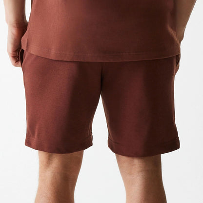 The Male model is wearing New York Yankees MLB Midi League Essential Brown Shorts 5