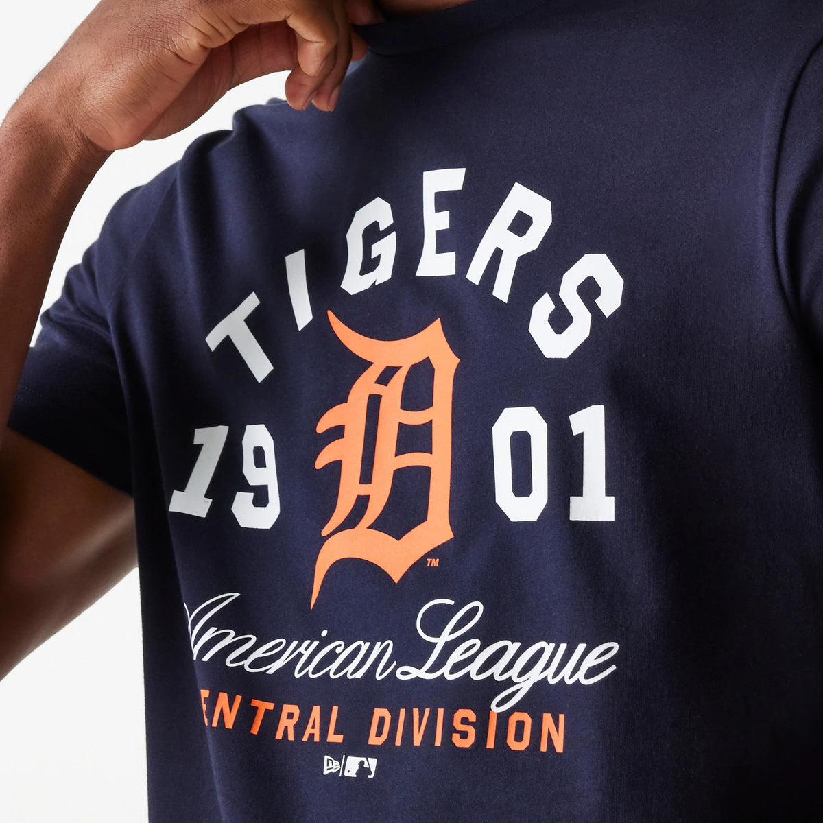 New Era Detroit Tigers MLB Wordmark Navy T-Shirt, front view showing the white letters curved above an orange D logo on the chest, the numbers 19 and 01 on either side, and script text reading American League Central Division below.