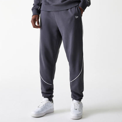 The Male model is wearing Boston Celtics NBA Piping Dark Grey Joggers 1