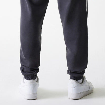 The Male model is wearing Boston Celtics NBA Piping Dark Grey Joggers 7