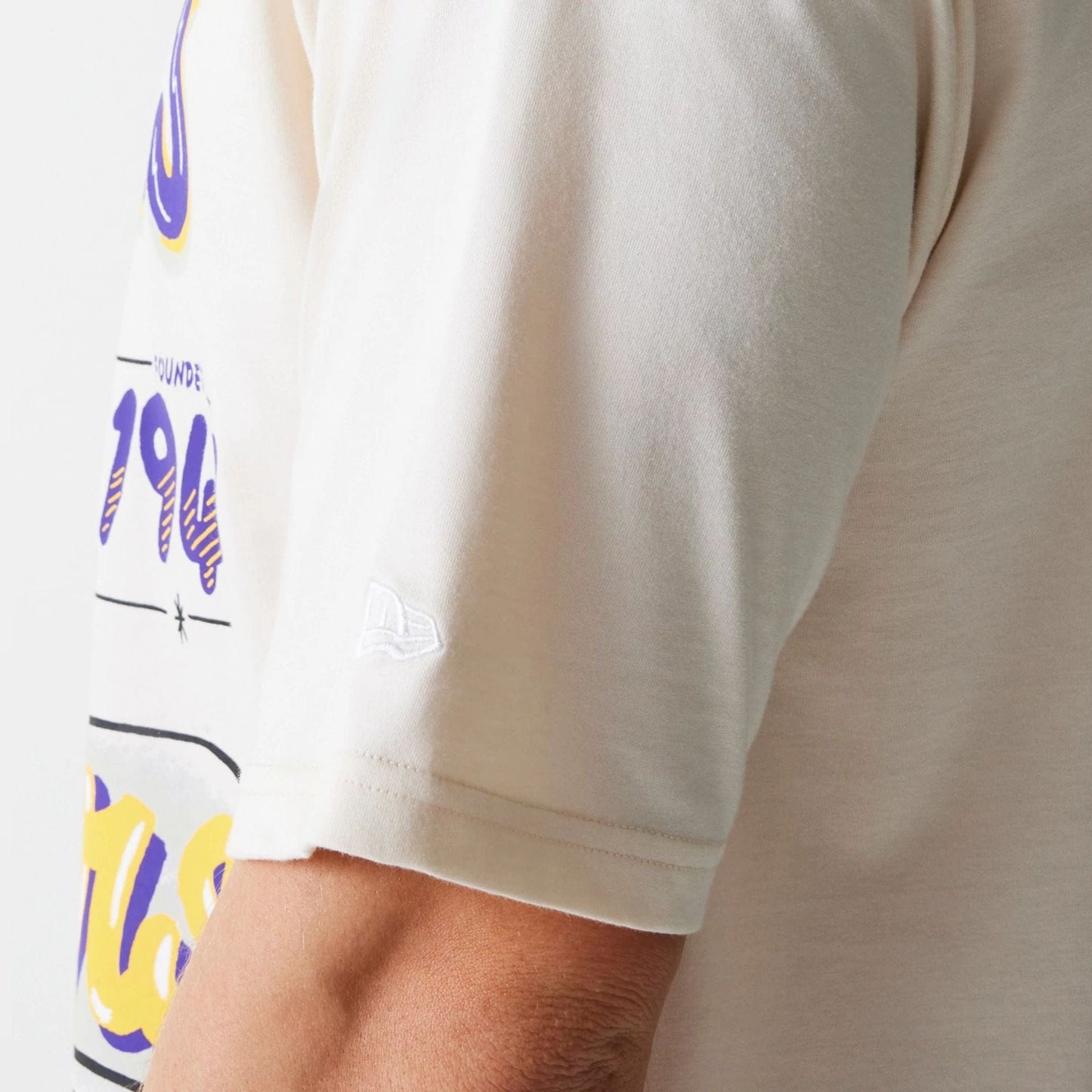 The Male model is wearing LA Lakers NBA Graphic Light Beige Oversized T-Shirt 5