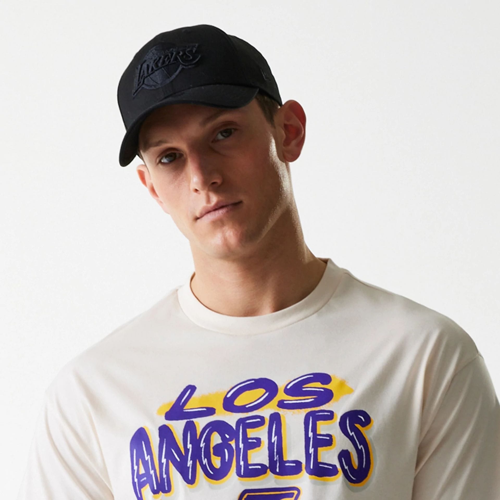 The Male model is wearing LA Lakers NBA Graphic Light Beige Oversized T-Shirt 6