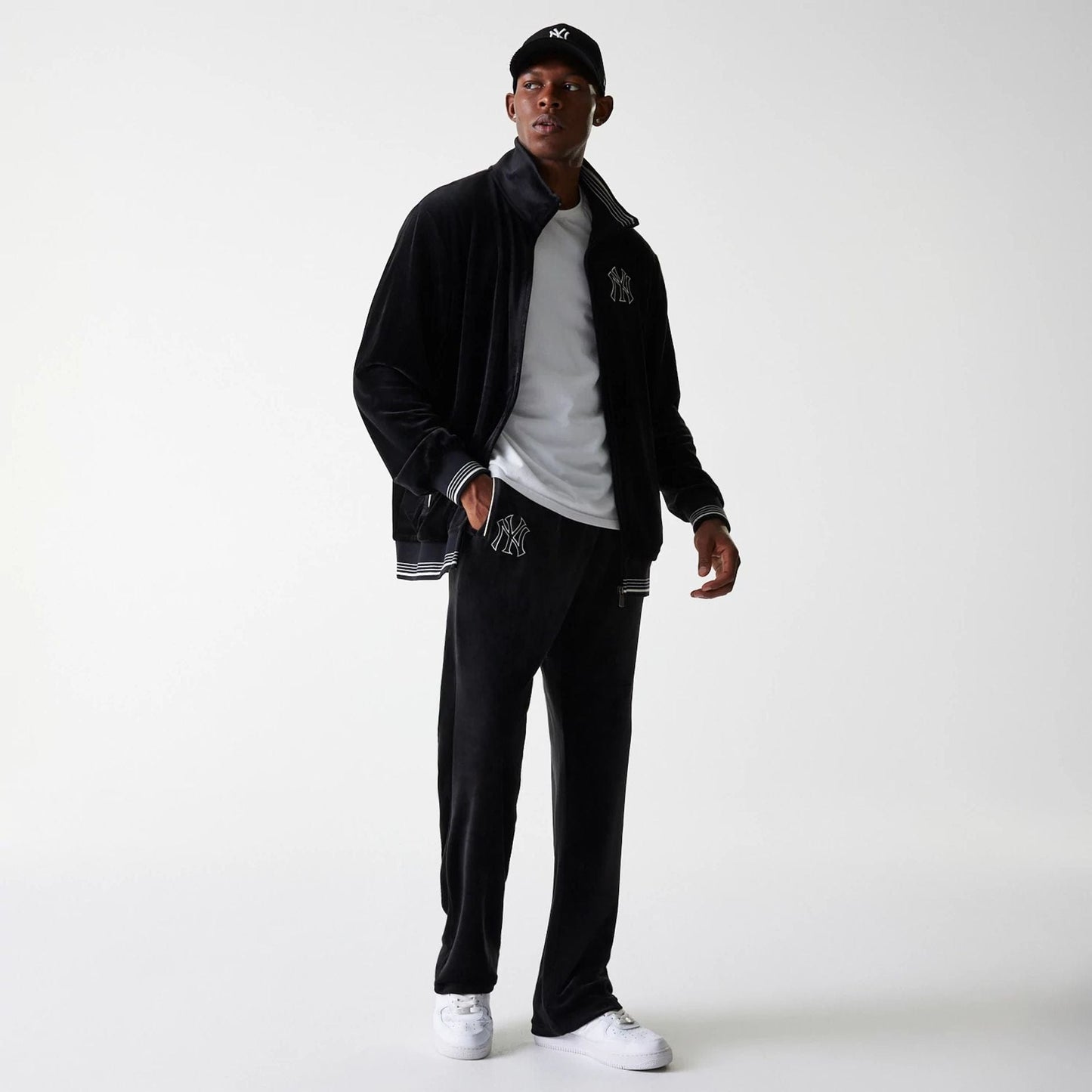 The Male model is wearing New York Yankees MLB Velour Black Track Pants 3