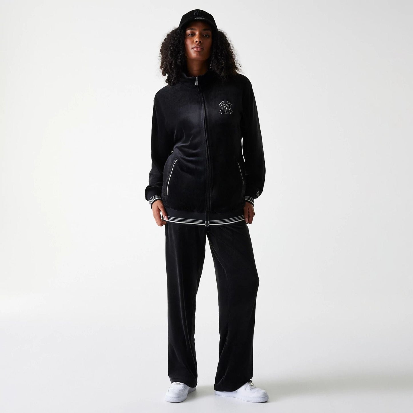 The Male model is wearing New York Yankees MLB Velour Black Track Pants 4