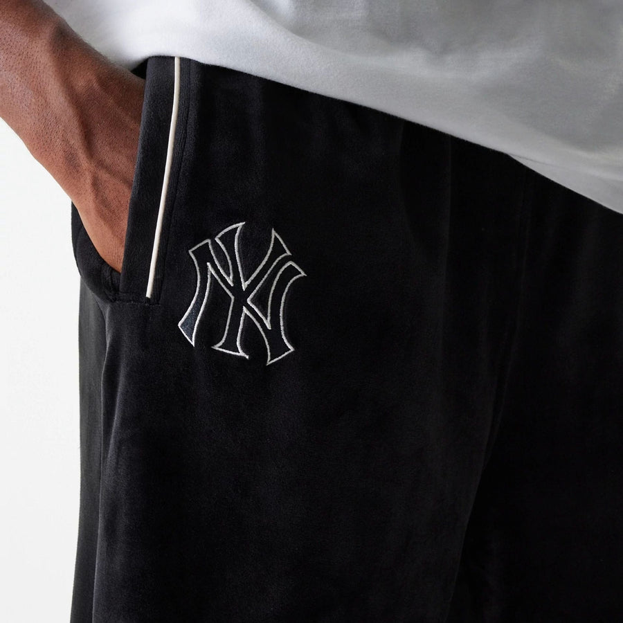 The Male model is wearing New York Yankees MLB Velour Black Track Pants 6