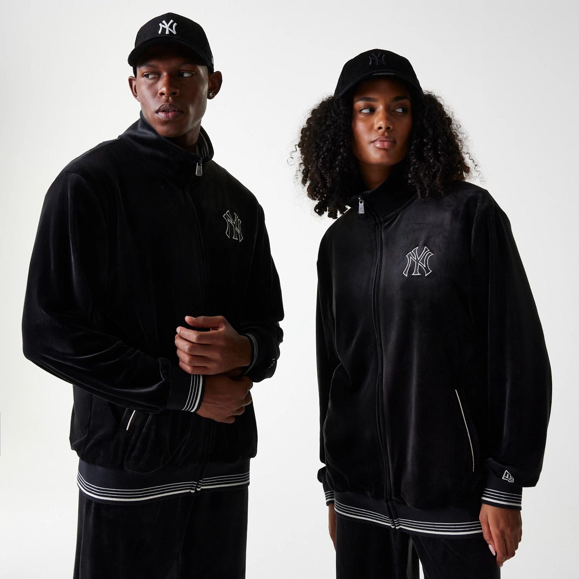 The Male model is wearing New York Yankees MLB Velour Black Track Top 1