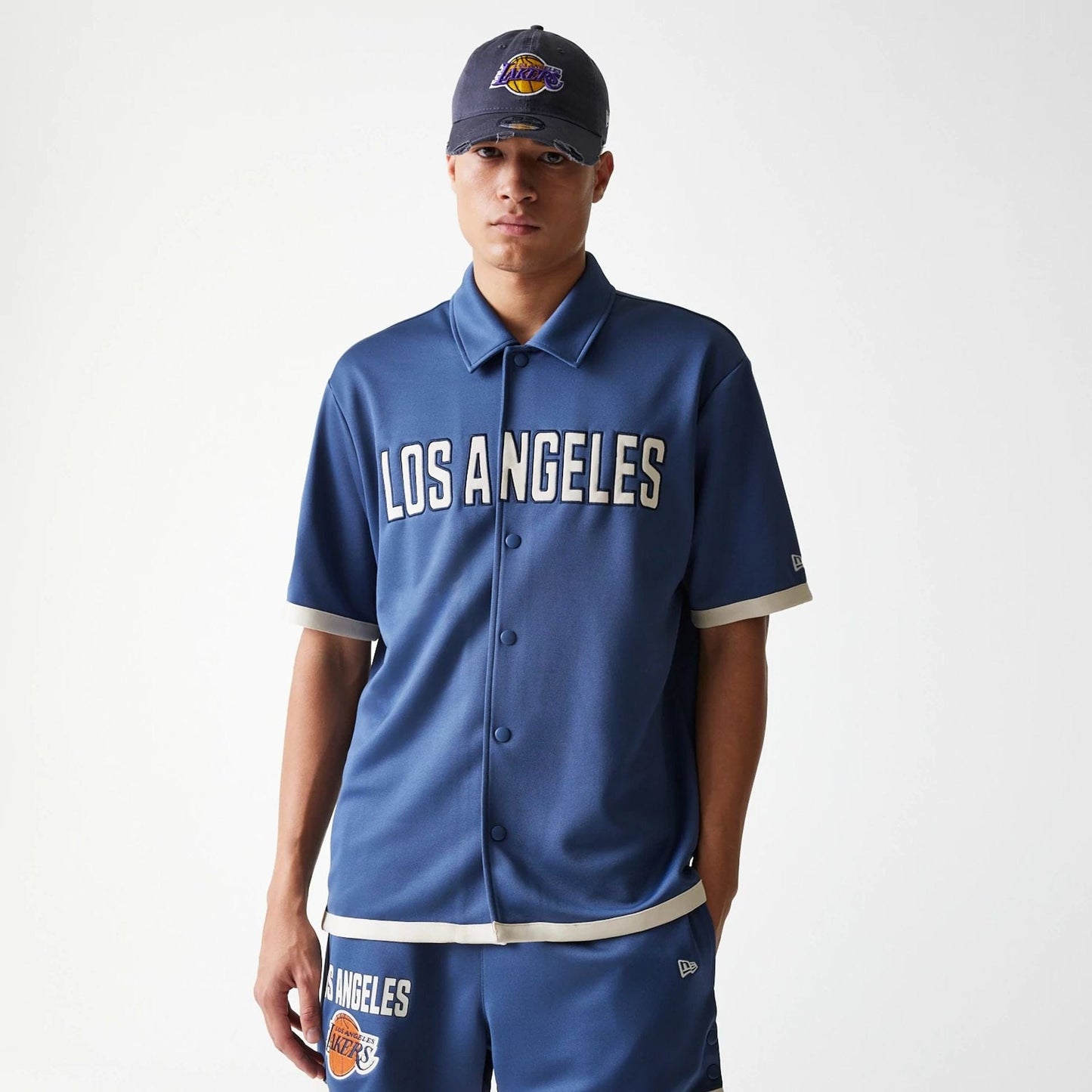 The Male model is wearing LA Lakers NBA Snap Button Dark Blue Short Sleeve Shirt 1