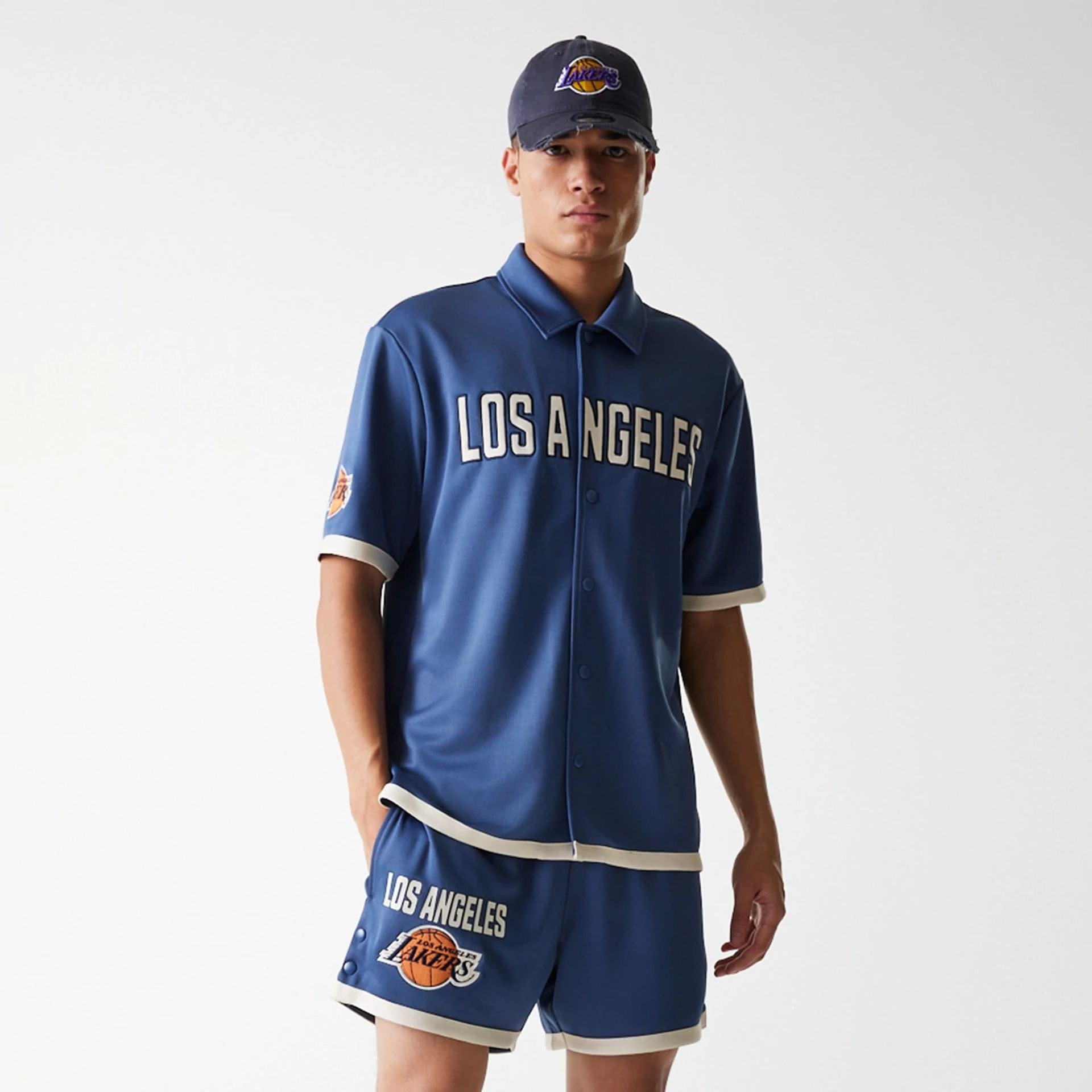 The Male model is wearing LA Lakers NBA Snap Button Dark Blue Short Sleeve Shirt 3