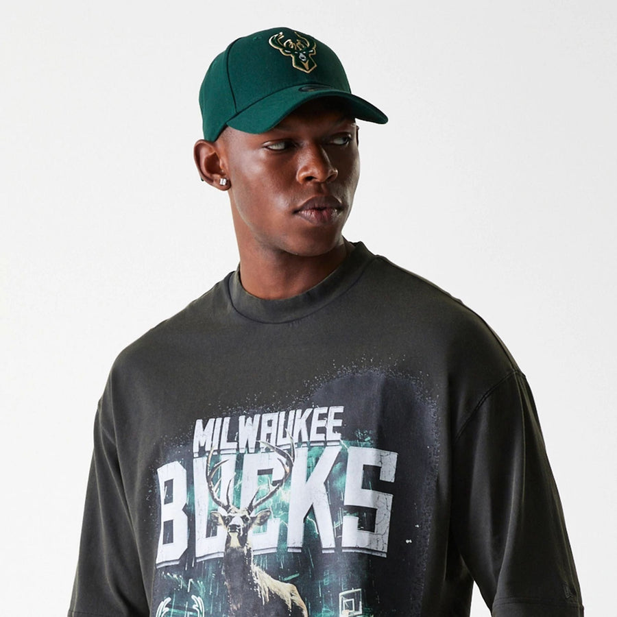 The Male model is wearing Milwaukee Bucks NBA Washed Graphic Grey T-Shirt 5