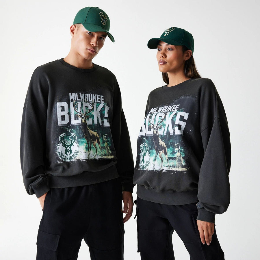 The Male model is wearing Milwaukee Bucks NBA Washed Graphic Grey Oversized Crew Neck Sweater 1