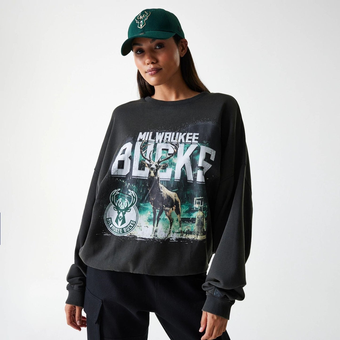 The Male model is wearing Milwaukee Bucks NBA Washed Graphic Grey Oversized Crew Neck Sweater 4