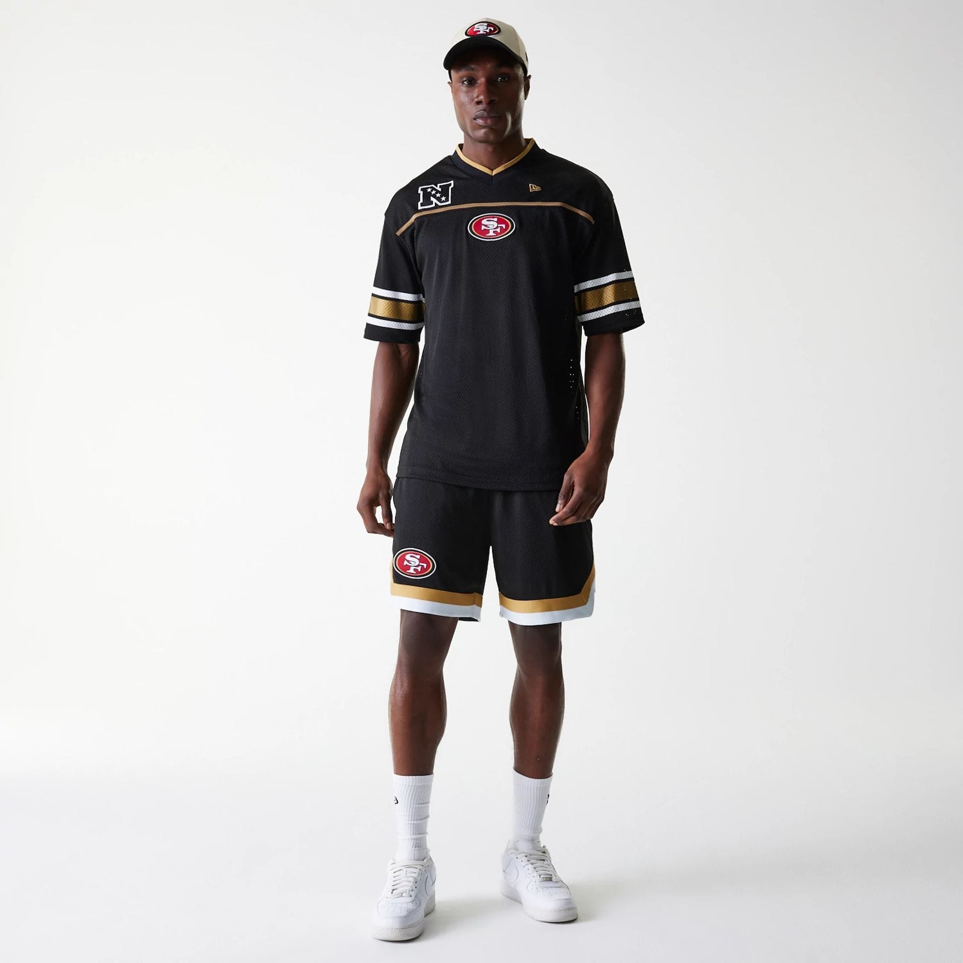 The Male model is wearing San Francisco 49ers NFL Mesh Black Shorts 8