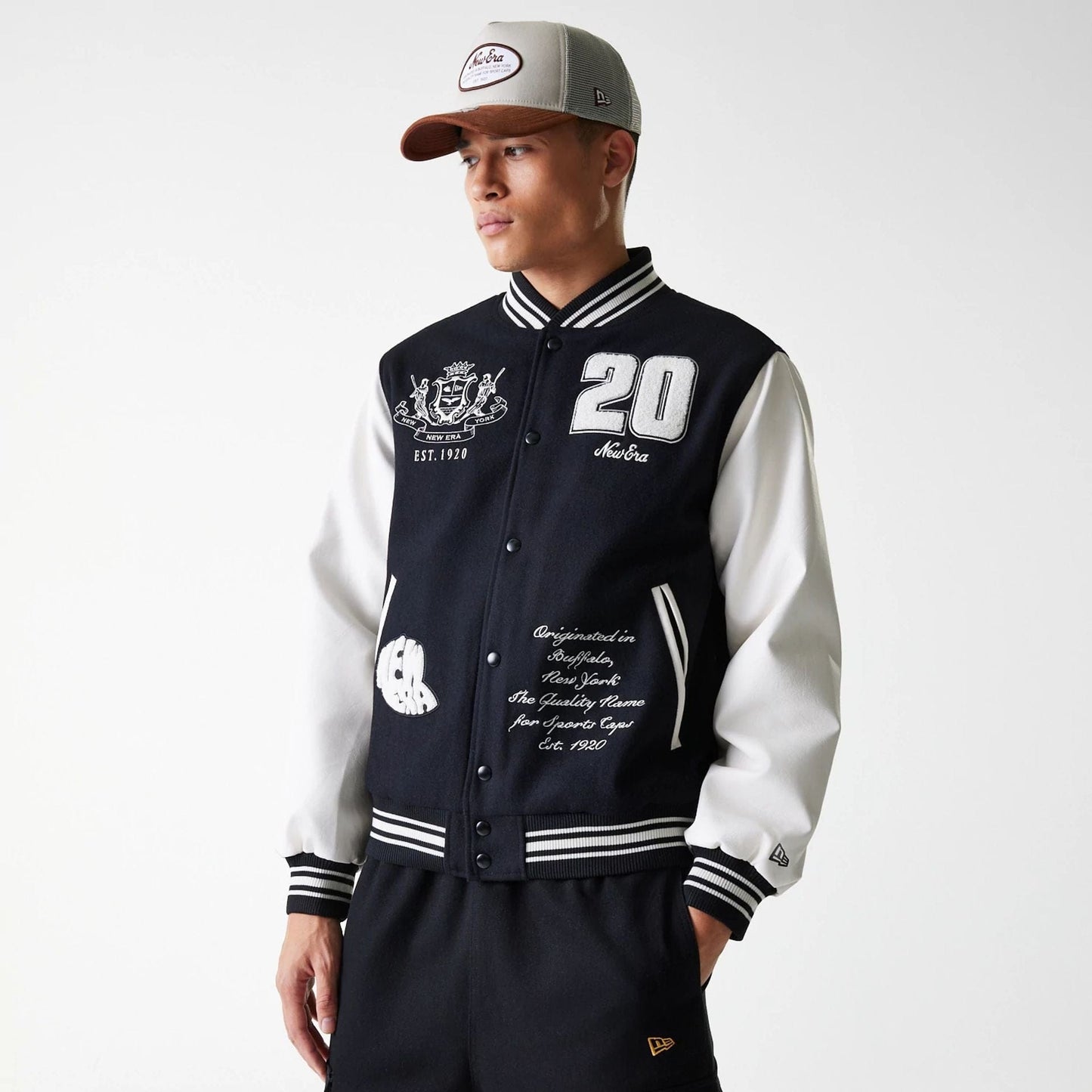The Male model is wearing New Era Patch Black Varsity Jacket 3