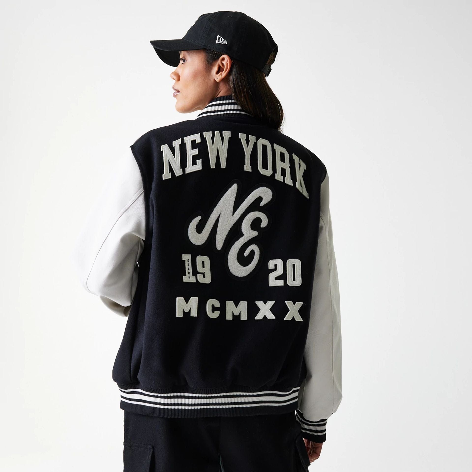 The Male model is wearing New Era Patch Black Varsity Jacket 2