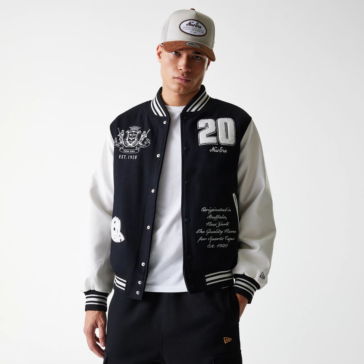 The Male model is wearing New Era Patch Black Varsity Jacket 4