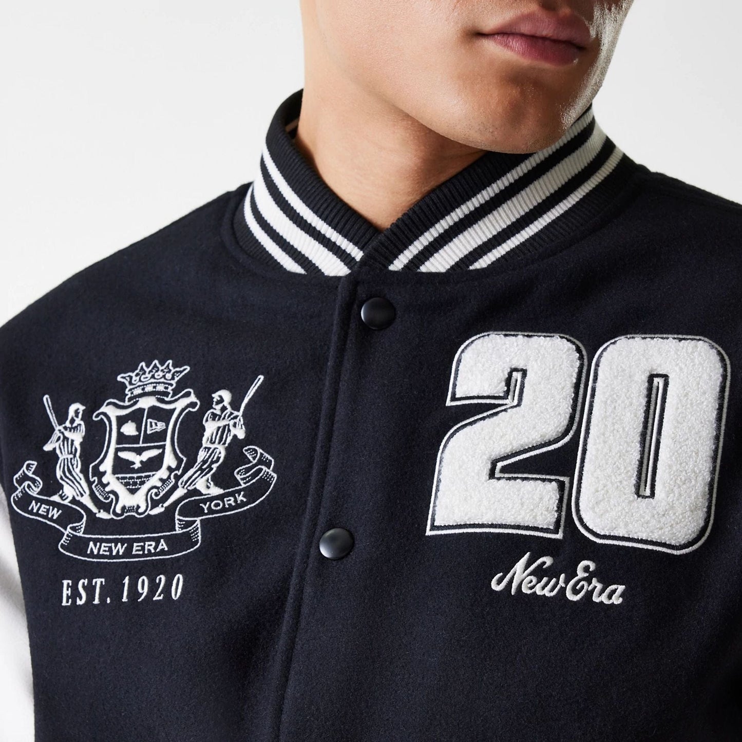 The Male model is wearing New Era Patch Black Varsity Jacket 5