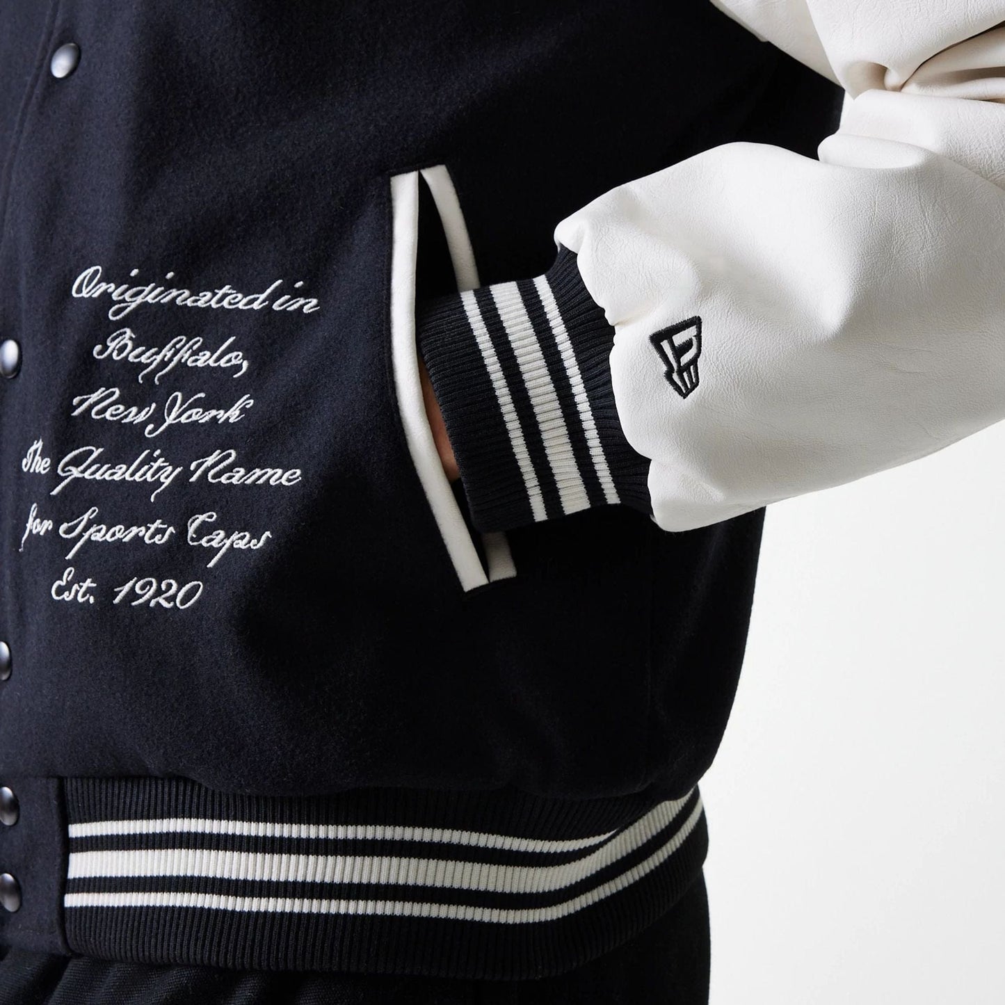 The Male model is wearing New Era Patch Black Varsity Jacket 6