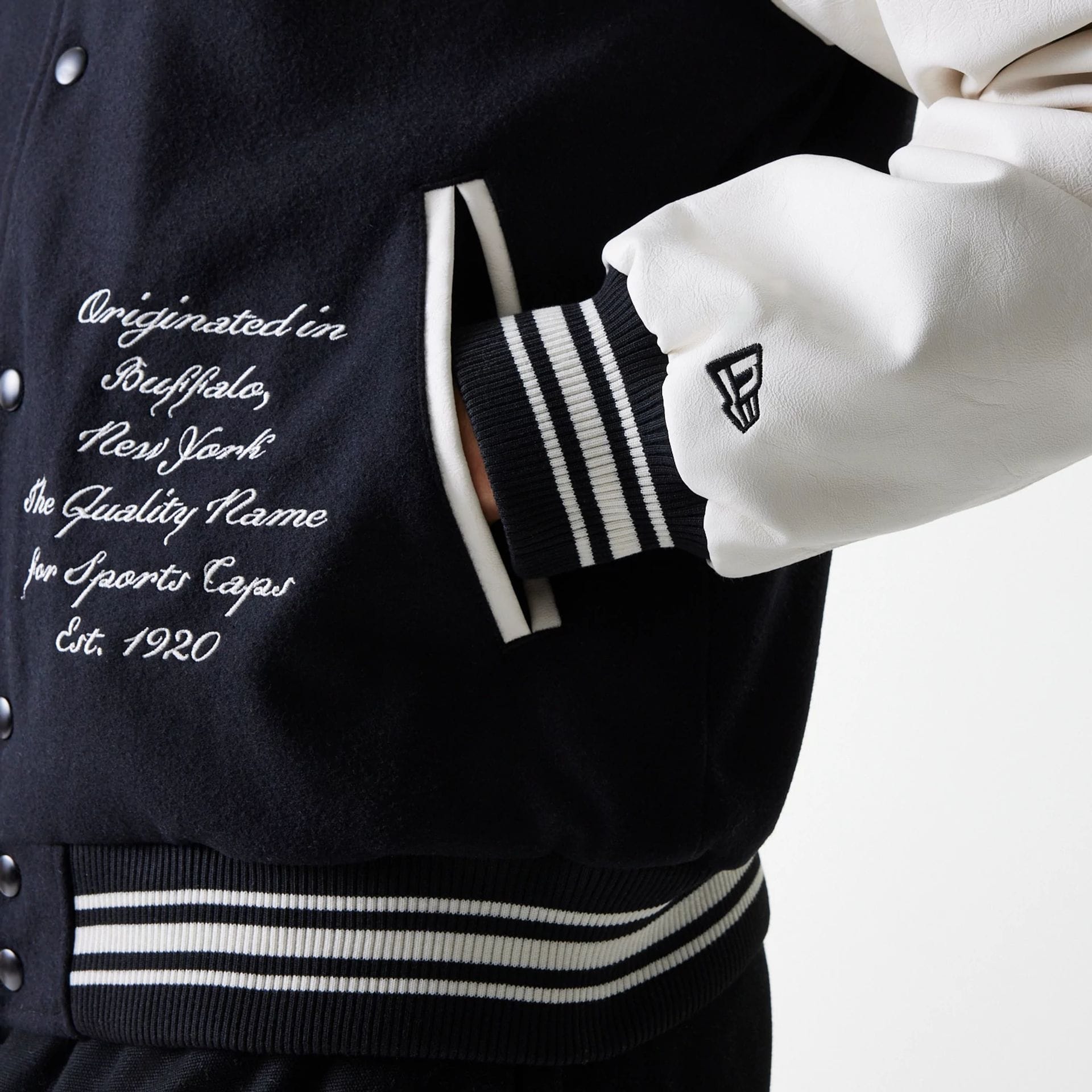 The Male model is wearing New Era Patch Black Varsity Jacket 6