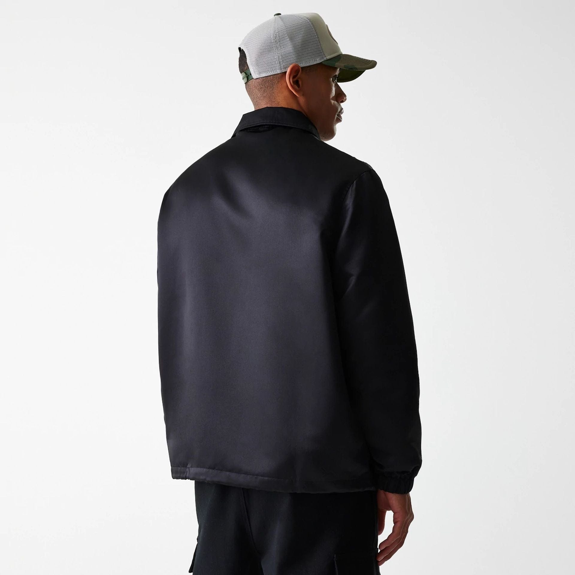 The Male model is wearing New Era Black Coaches Jacket 2