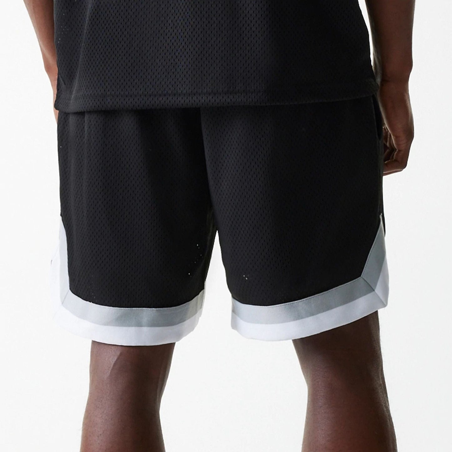 The Male model is wearing Las Vegas Raiders NFL Mesh Black Shorts 6