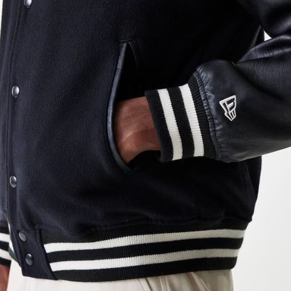 The Male model is wearing New Era Black Hooded Varsity Jacket 5