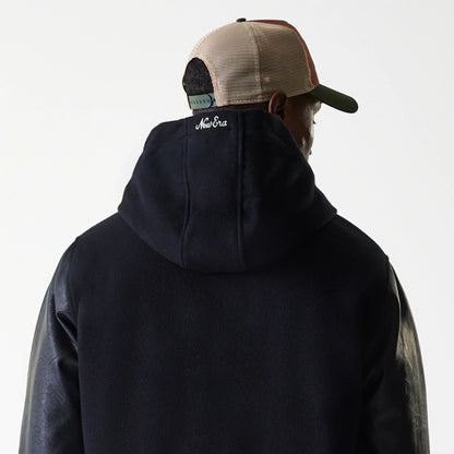 The Male model is wearing New Era Black Hooded Varsity Jacket 7