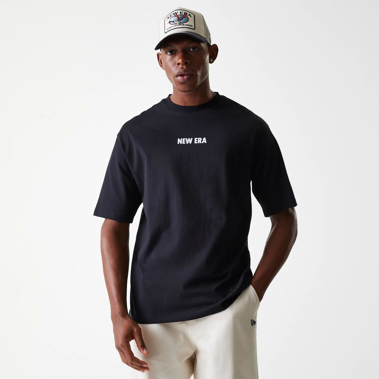 The Male model is wearing New Era Graphic Black Oversized T-Shirt 1