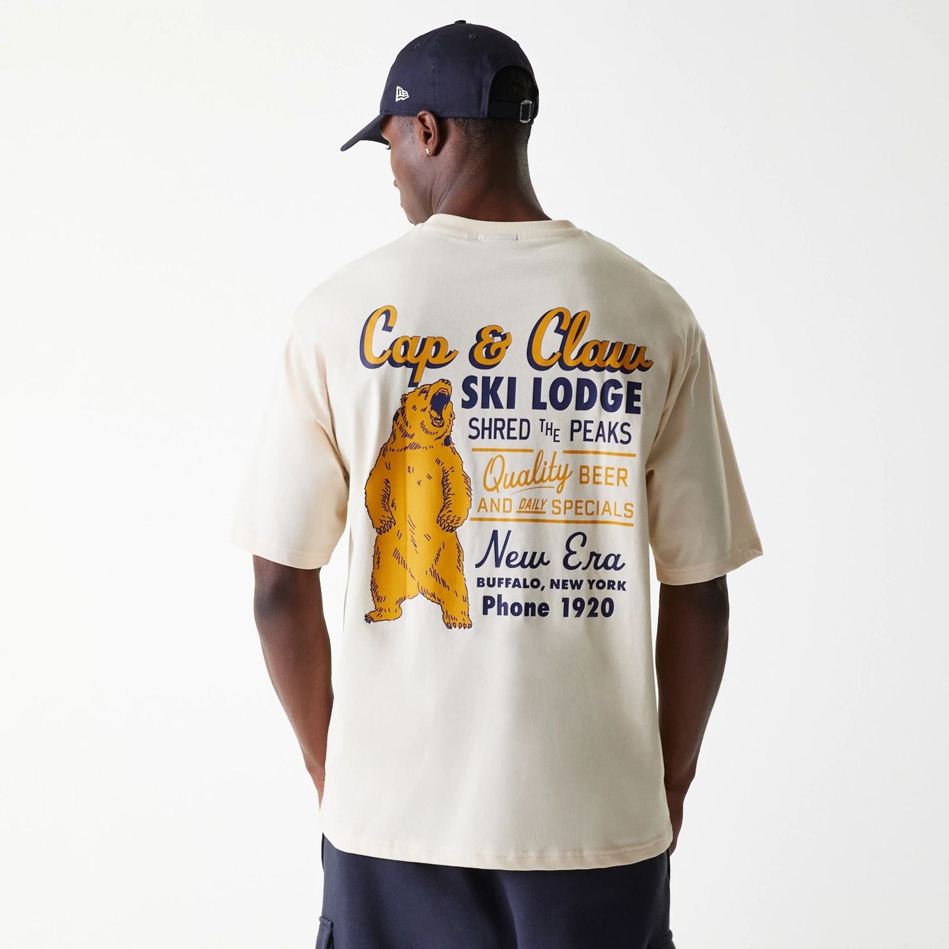 The Male model is wearing New Era Animal Graphic Light Beige Oversized T-Shirt 2