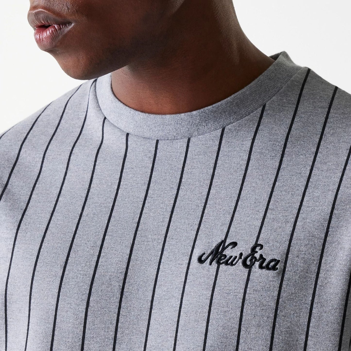 The Male model is wearing New Era Pinstripe Pastel Grey Oversized T-Shirt 4