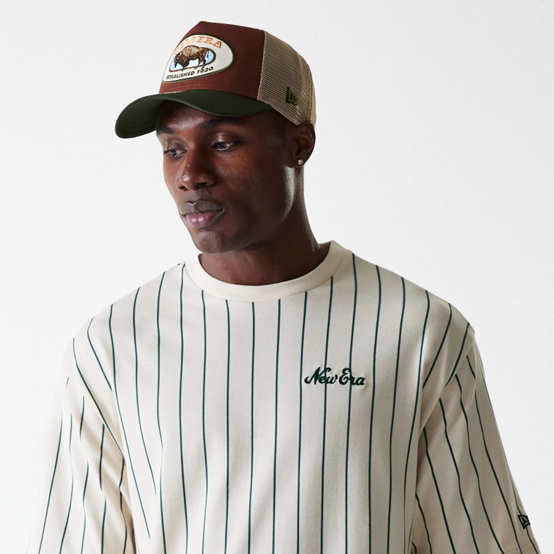 The Male model is wearing New Era Pinstripe Light Beige Oversized T-Shirt 5
