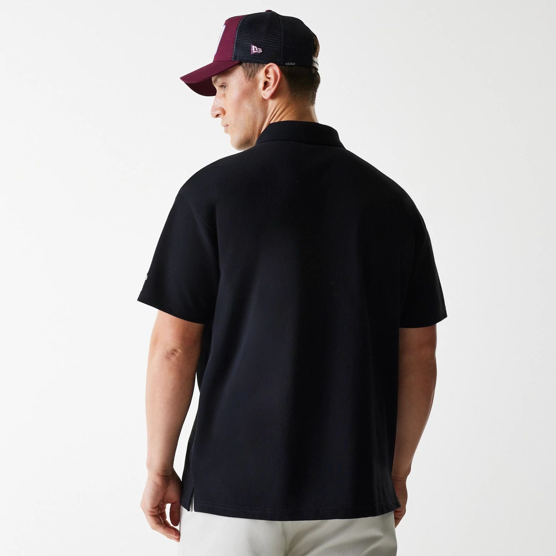The Male model is wearing New Era Script Black Polo T-Shirt 2