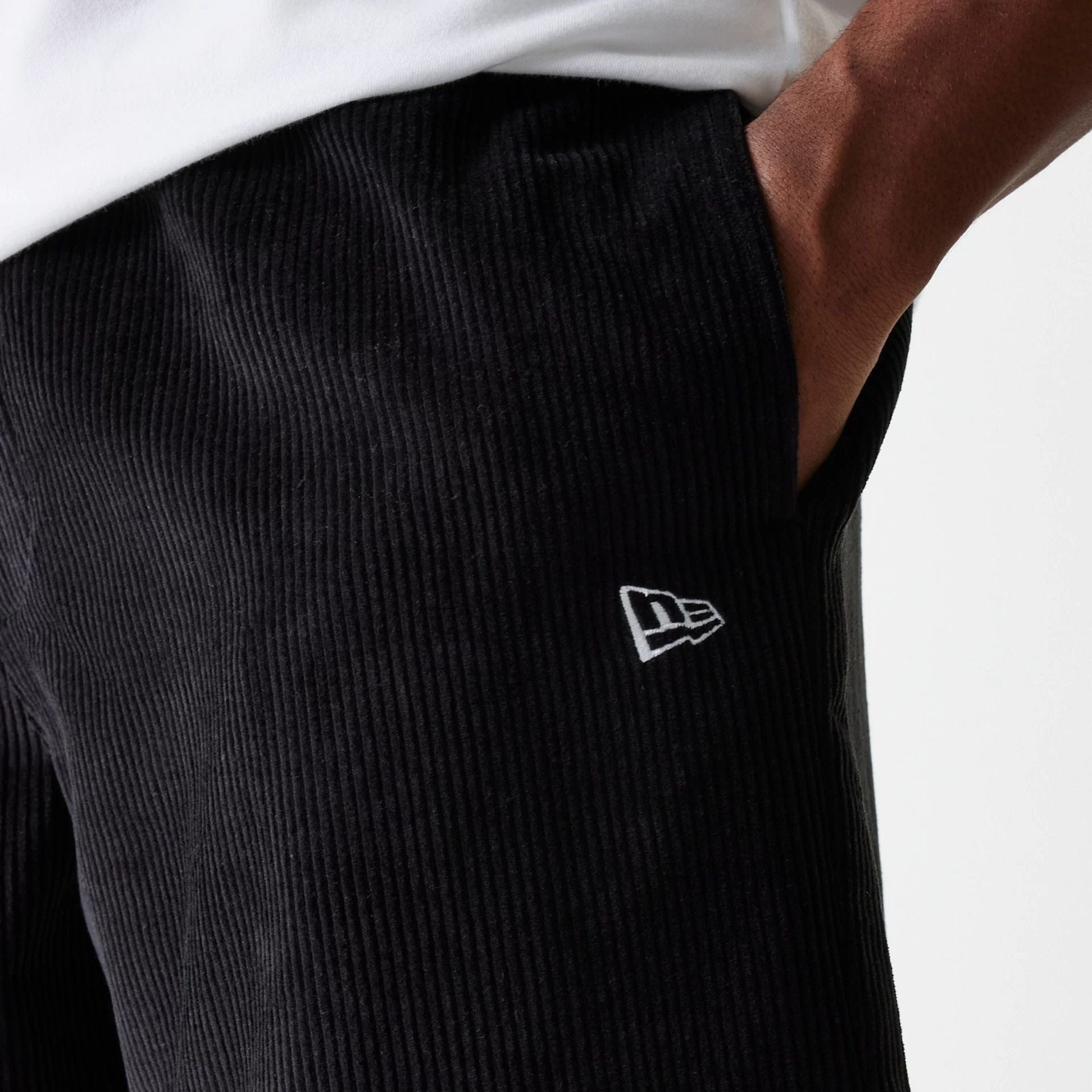 The Male model is wearing New Era Cord Black Shorts 4