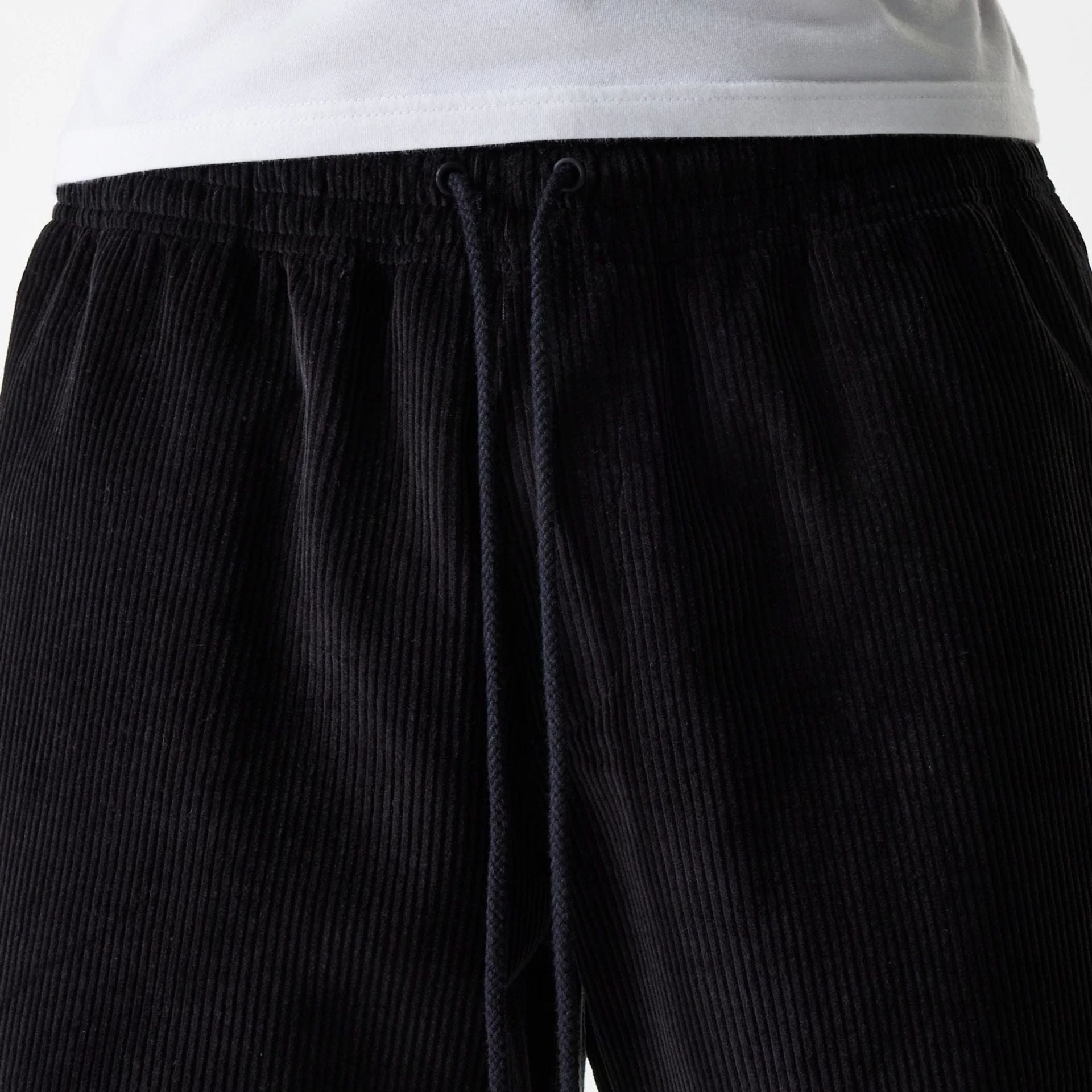 The Male model is wearing New Era Cord Black Shorts 5