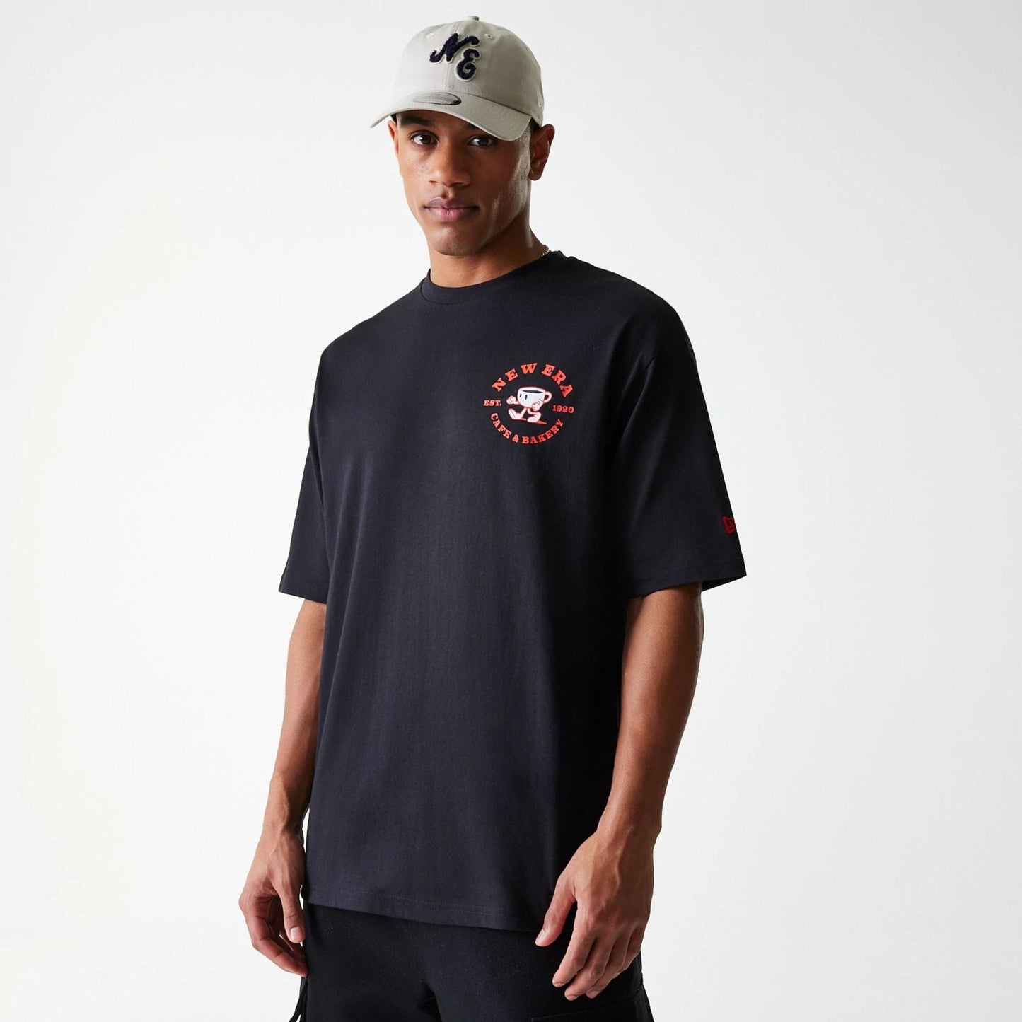 The Male model is wearing New Era Cafe Graphic Black Oversized T-Shirt 3